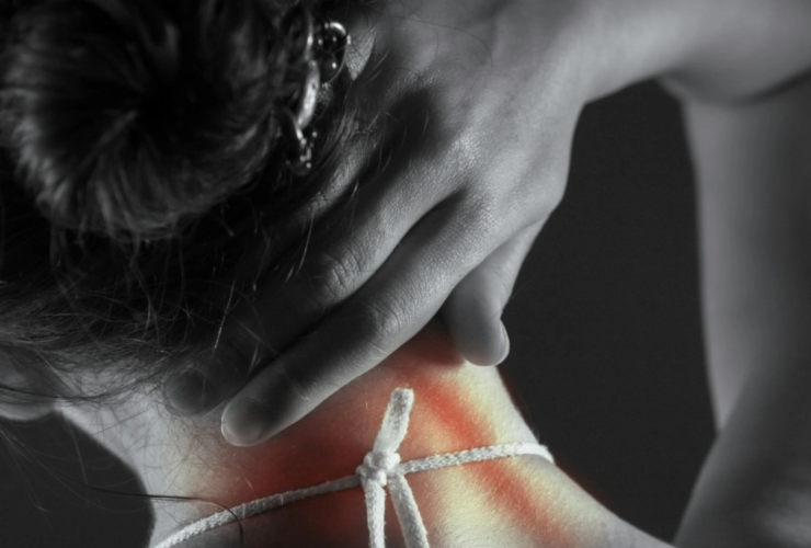a close up of a woman's neck highlighting the painful area