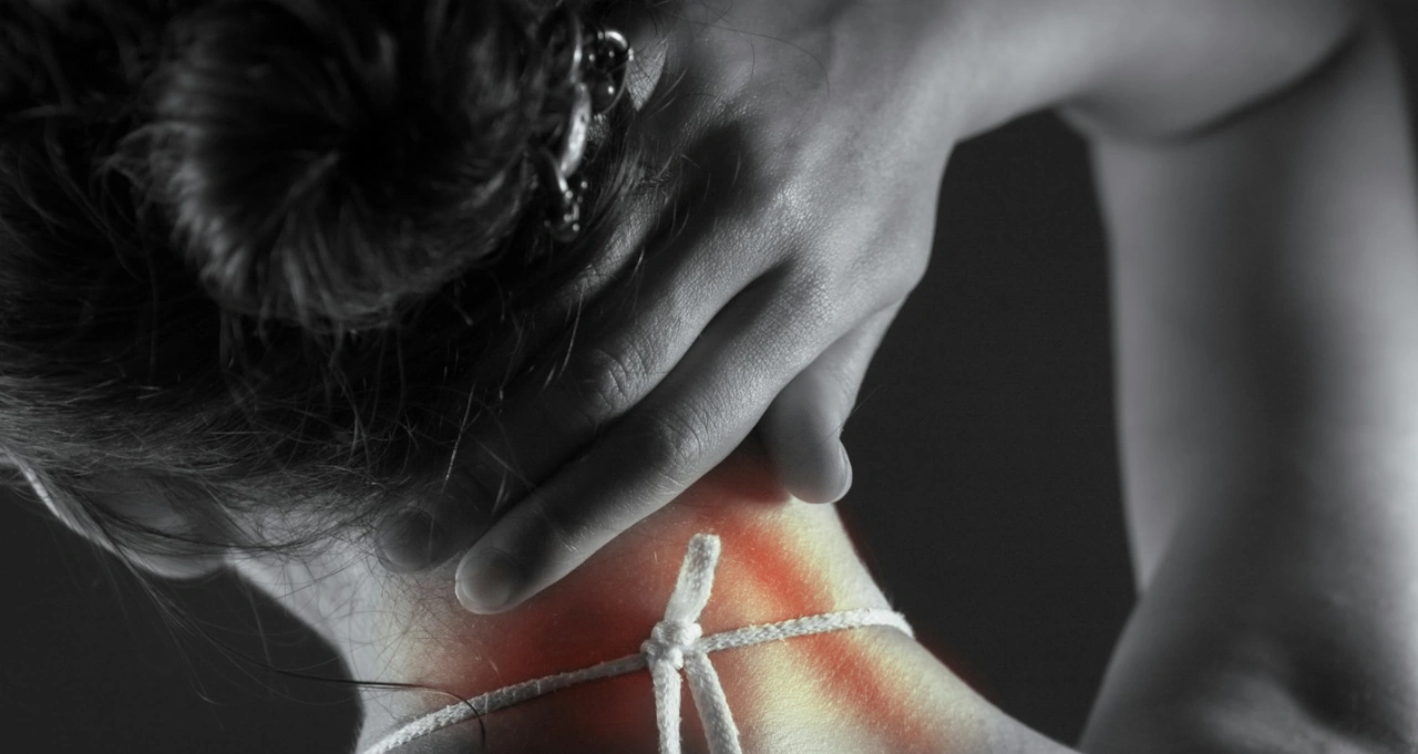 a close up of a woman's neck highlighting the painful area