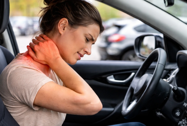 Woman sitting in a car holding her neck with delayed pain after a car accident Title: Delayed Neck Pain After a Car Accident in Everett WA